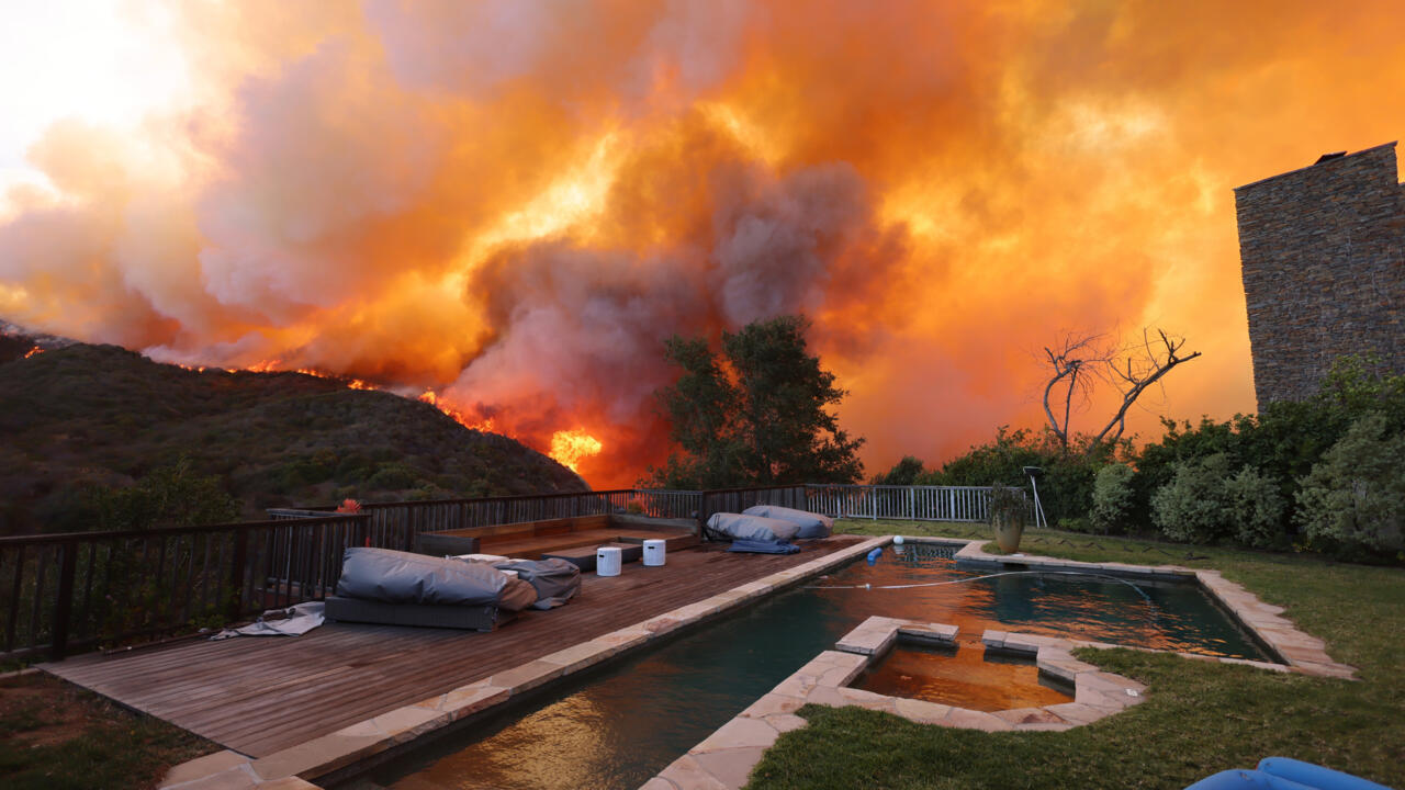 Wildfire sparks panicked evacuations in Los Angeles suburb